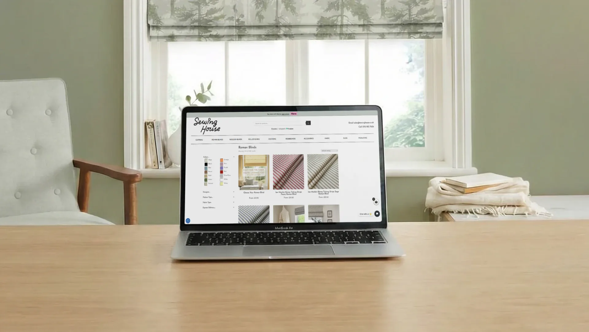 Sewing House e-commerce site rendered on a MacBook in a sage-green room.